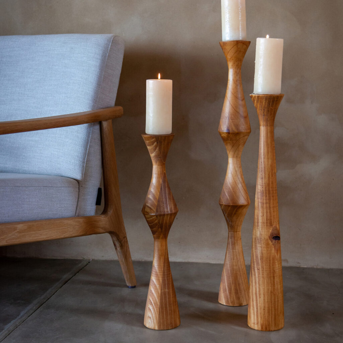 Geometric Floor Candle Holders next to lounge chair